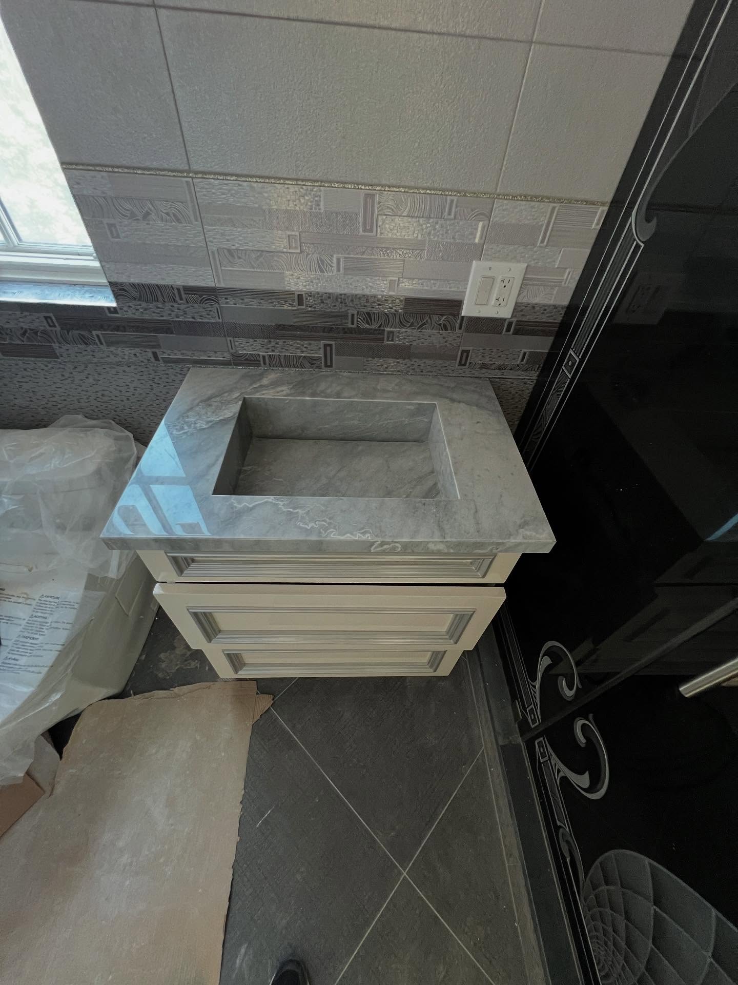 Marble vanity with integrated sinks by Fine Stone Works